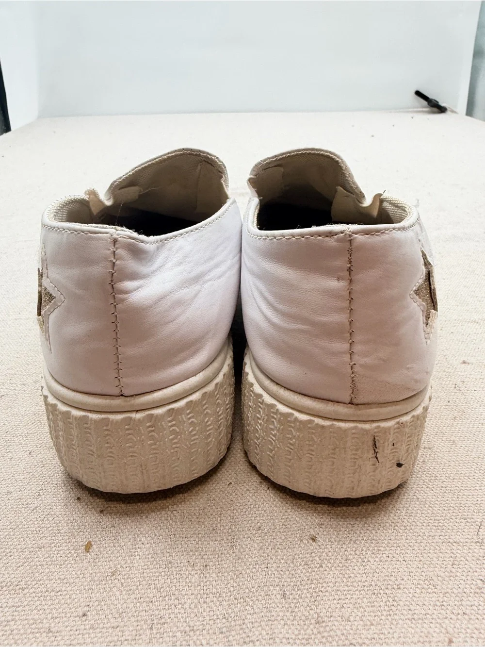 ' White Slip-On Sneakers with Gold Star Accents